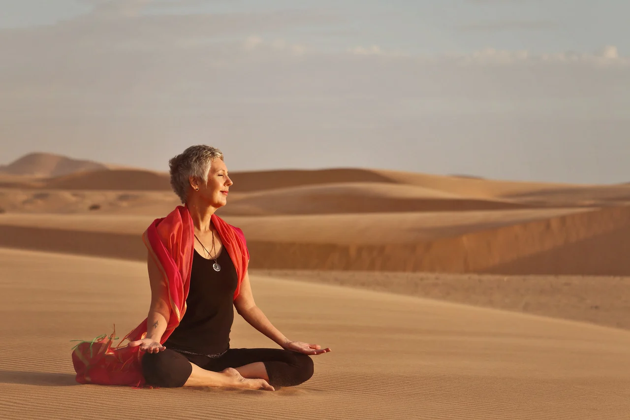 Gabi meditating peacefully among the Namib dunes