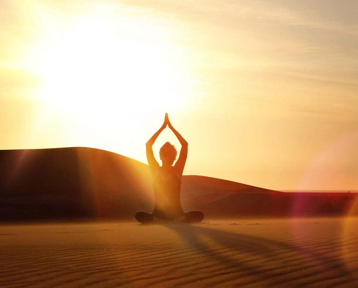 Gabi practising yoga at sunrise in the Namib Desert